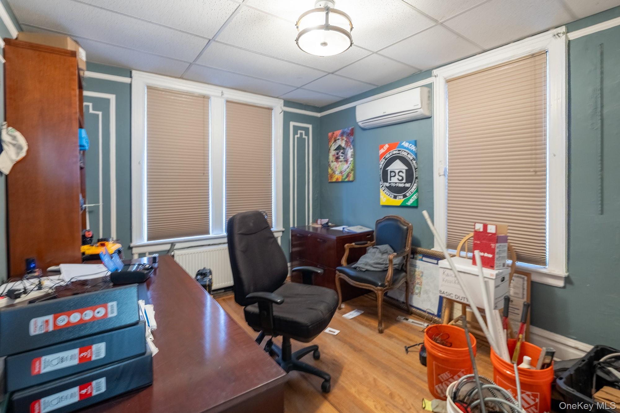 677 Van Nest Avenue Bronx, NY 10462 - Photo 22 of 49 a work room with furniture a rug and a window