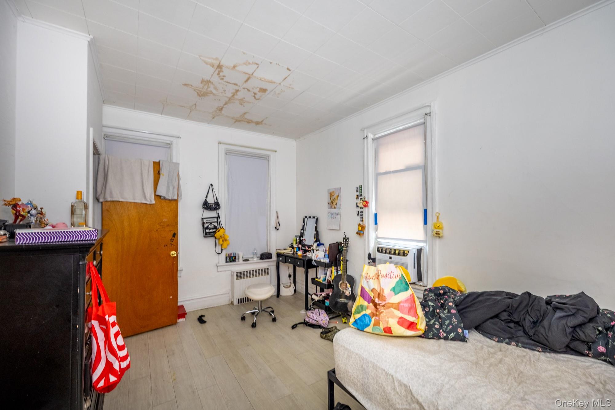 677 Van Nest Avenue Bronx, NY 10462 - Photo 29 of 49 a bedroom with a bed and a chandelier