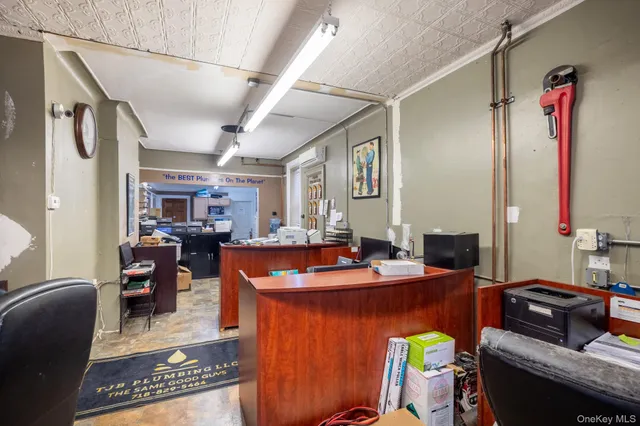 a dining room with furniture and a mirror