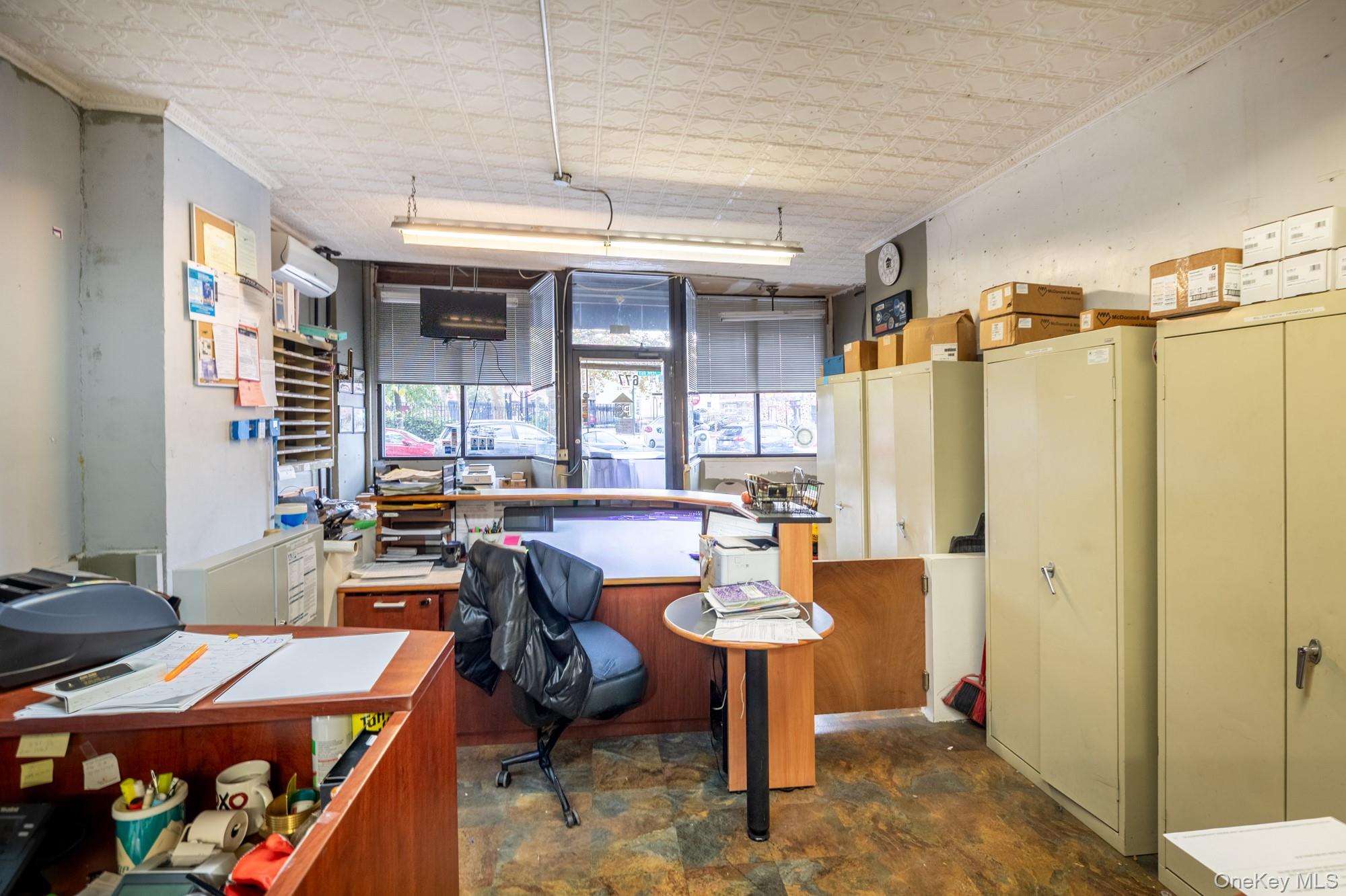 677 Van Nest Avenue Bronx, NY 10462 - Photo 6 of 49 a workspace with furniture and a chandelier