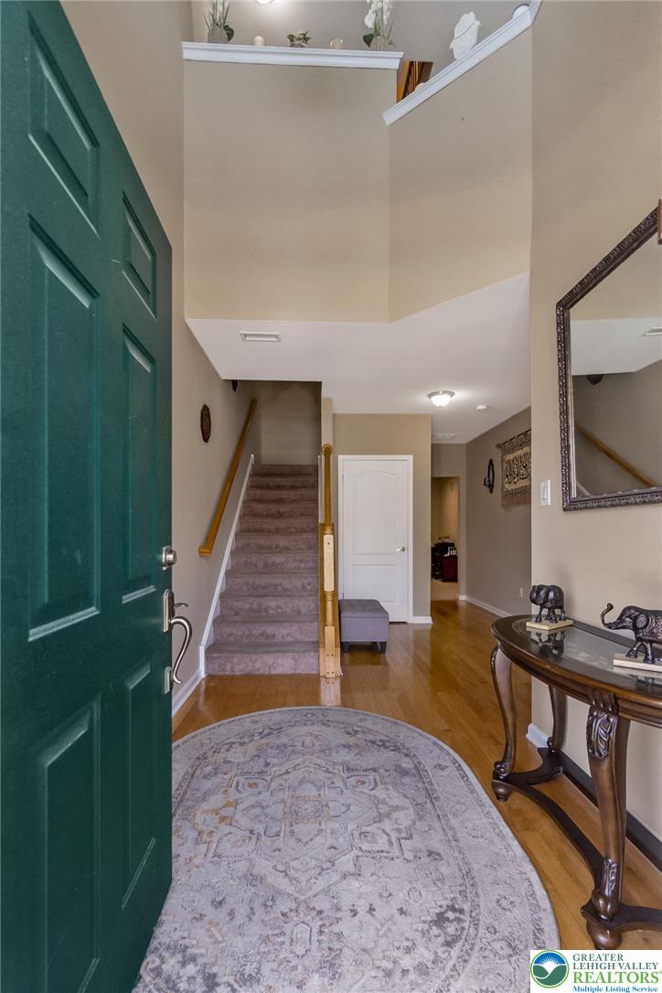 3566 Penfield Way Nazareth, PA 18064 - Photo 2 of 47 Enter into a welcoming foyer, featuring warm wood flooring and a carpeted staircase leading to upper levels.