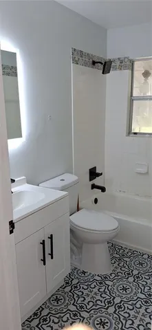 a white toilet sitting next to a bathroom sink