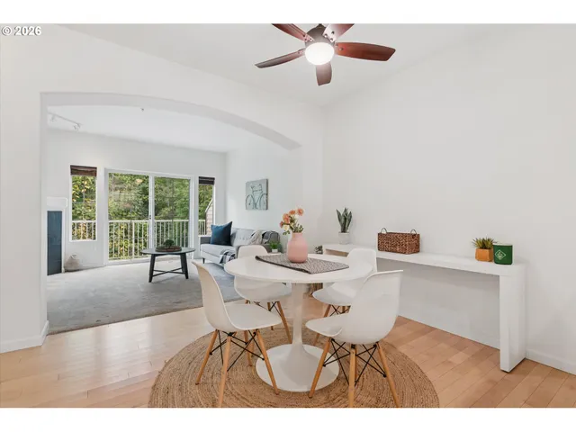 a view of a dining room with furniture and a large window