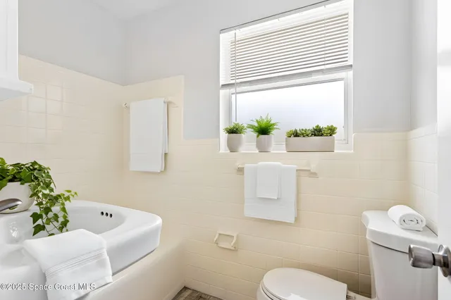 a white bath tub sitting next to a white sink