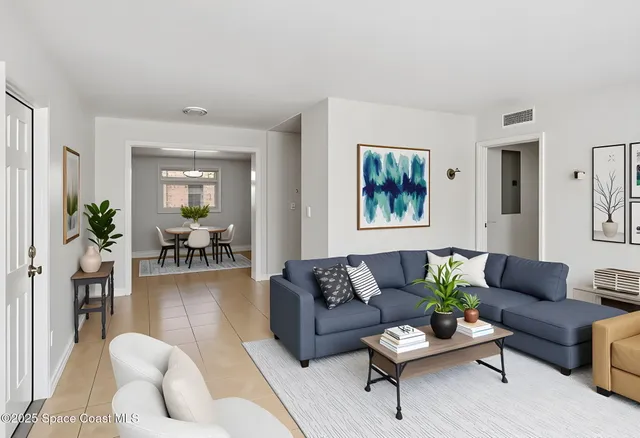 a living room with furniture potted plant and a window