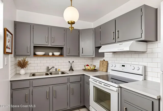 a kitchen with cabinets appliances and a sink