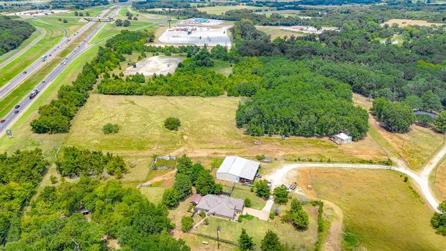 an aerial view of residential houses with yard
