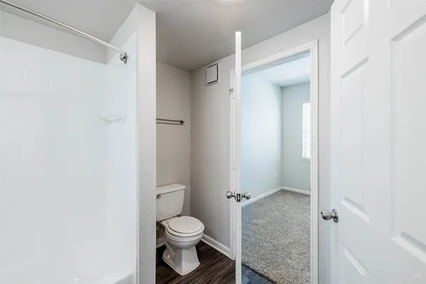a bathroom with a toilet and a shower