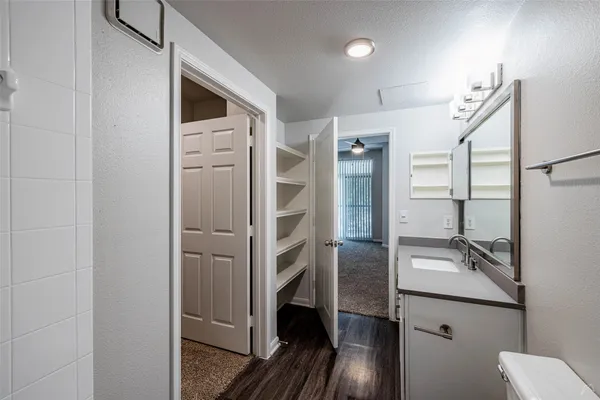 a bathroom with a double vanity sink a toilet and shower