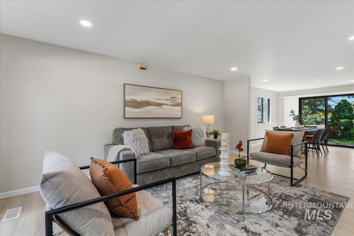 599 Pebble Beach Way Eagle, ID 83616 - Photo 6 of 44 Open-concept living area with light wood-finish flooring, recessed lighting, and a neutral color palette