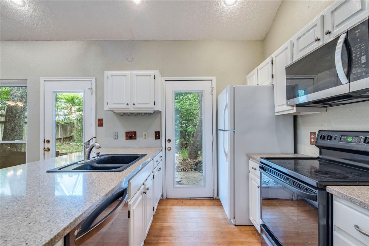 3809 Spicewood Springs Road, Unit 127 Austin, TX 78759 - Photo 10 of 29 Culinary aspirations come alive in this kitchen, featuring ample counter space and natural light.