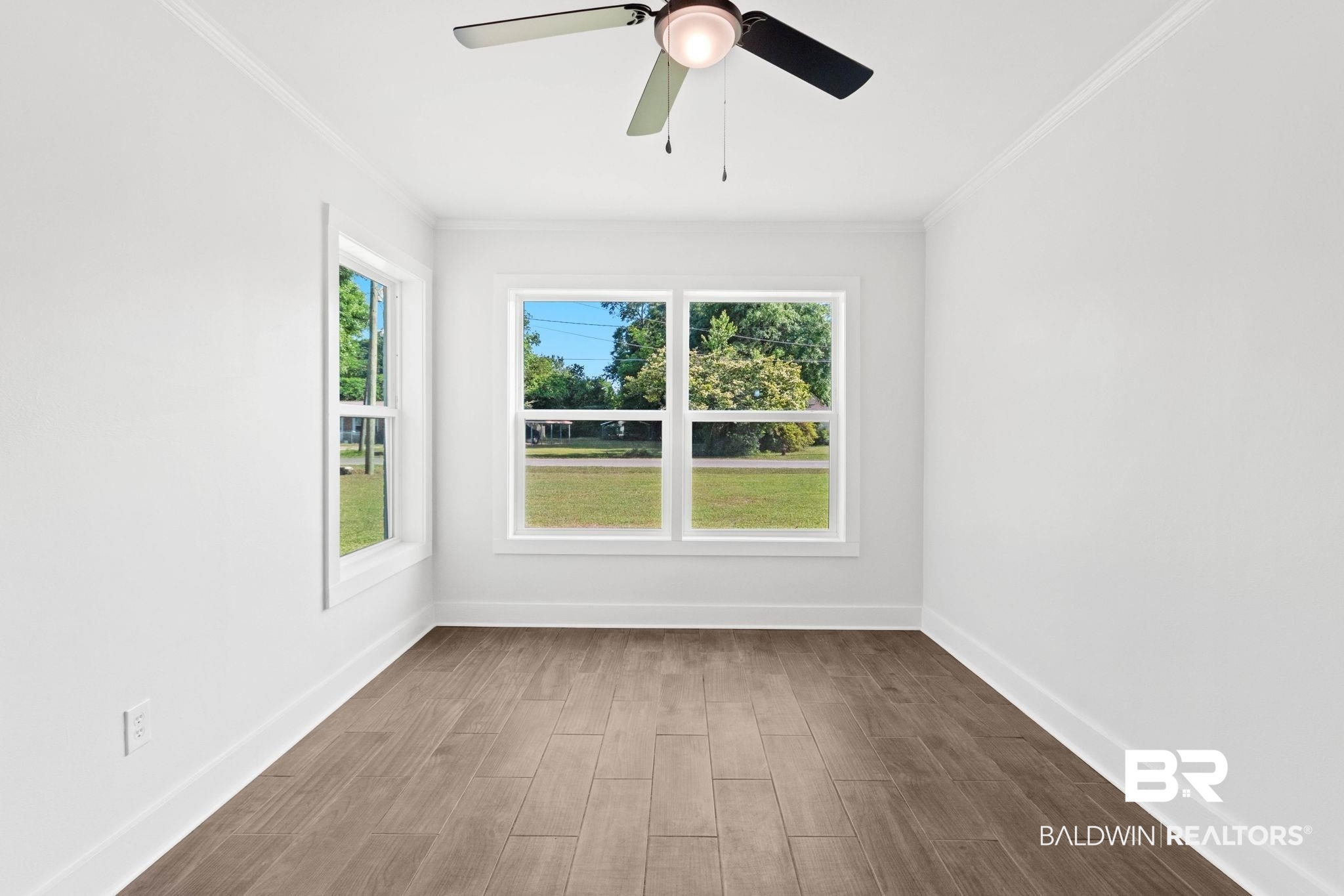 311 Cloverdale Road Atmore, AL 36502 - Photo 36 of 63 Bright room featuring wood-finish flooring, crisp white walls, and multiple double-hung windows