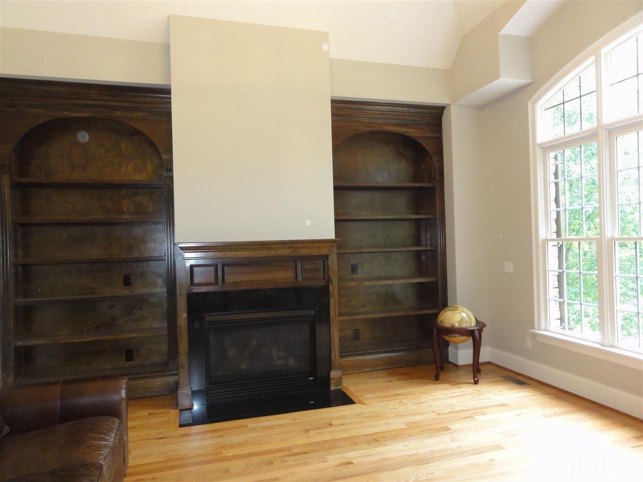 1408 Caistor Lane Raleigh, NC 27614 - Photo 1 of 18 Natural light flows into the private study. Gorgeous soaring ceiling with FIREPLACE and beautiful wood shelving. Refinished HARDWOODS and lots of privacy!
