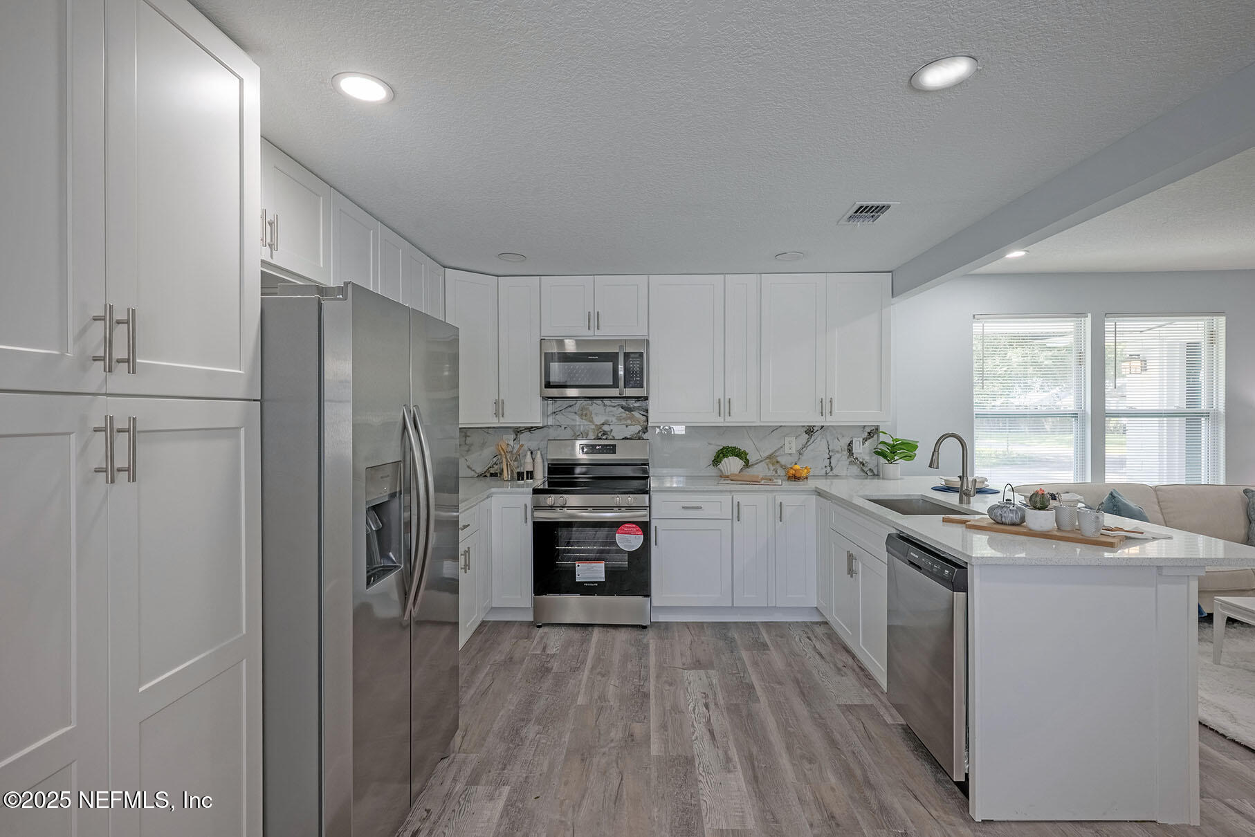 5401 Burdette Road Jacksonville, FL 32211 - Photo 12 of 53 a kitchen with cabinets and stainless steel appliances