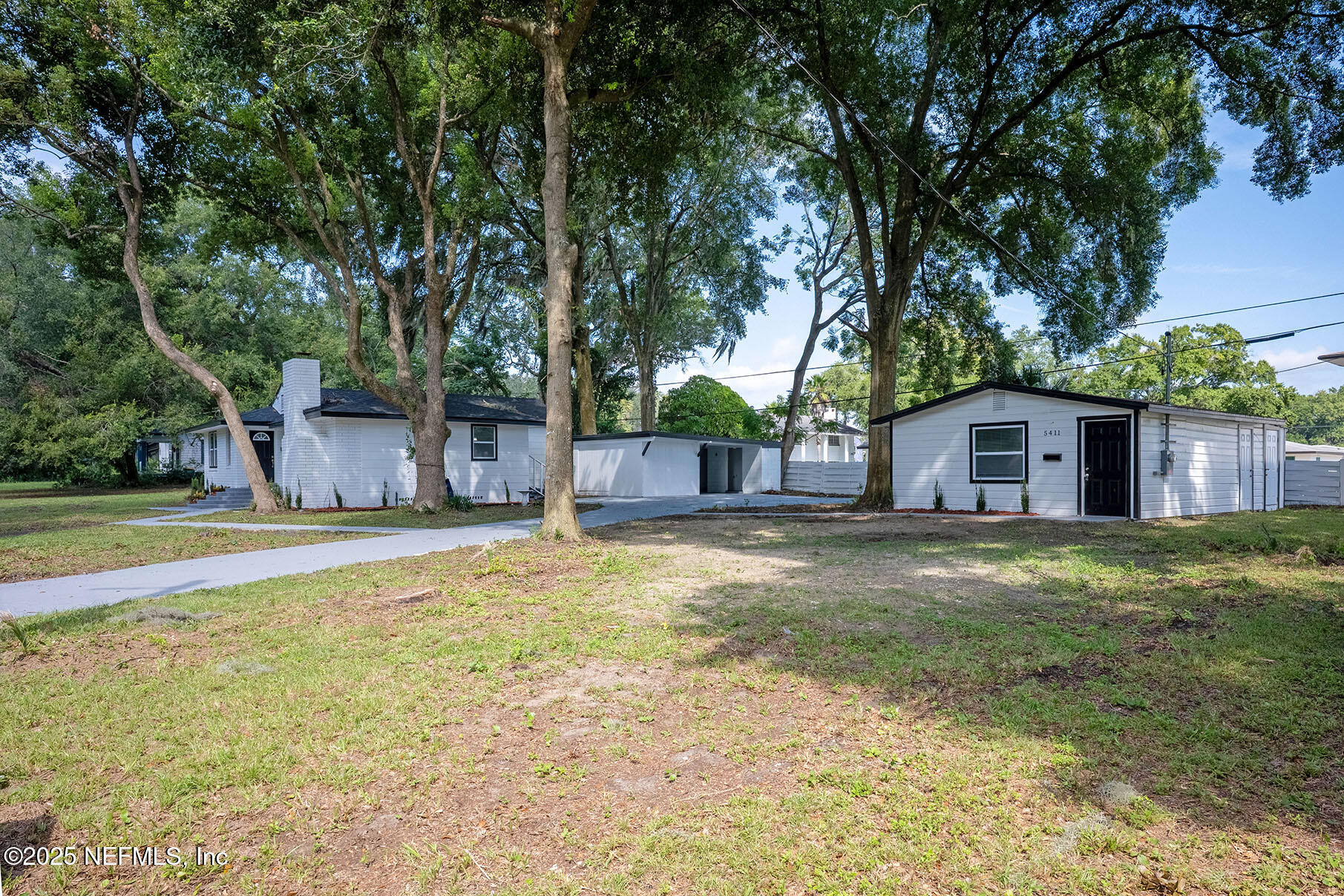 5401 Burdette Road Jacksonville, FL 32211 - Photo 3 of 53 a view of a backyard with large trees and wooden fence