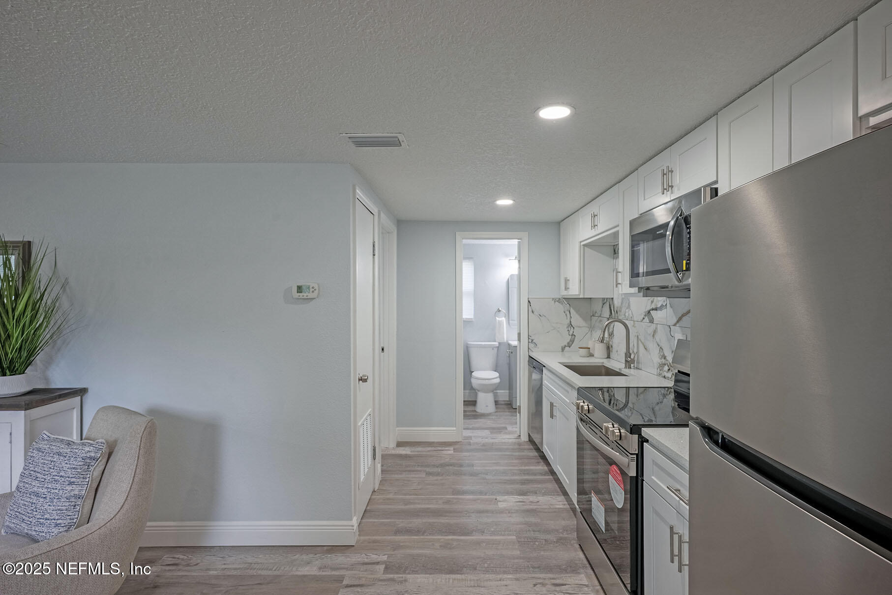 5401 Burdette Road Jacksonville, FL 32211 - Photo 38 of 53 a kitchen with stainless steel appliances granite countertop a refrigerator and a sink