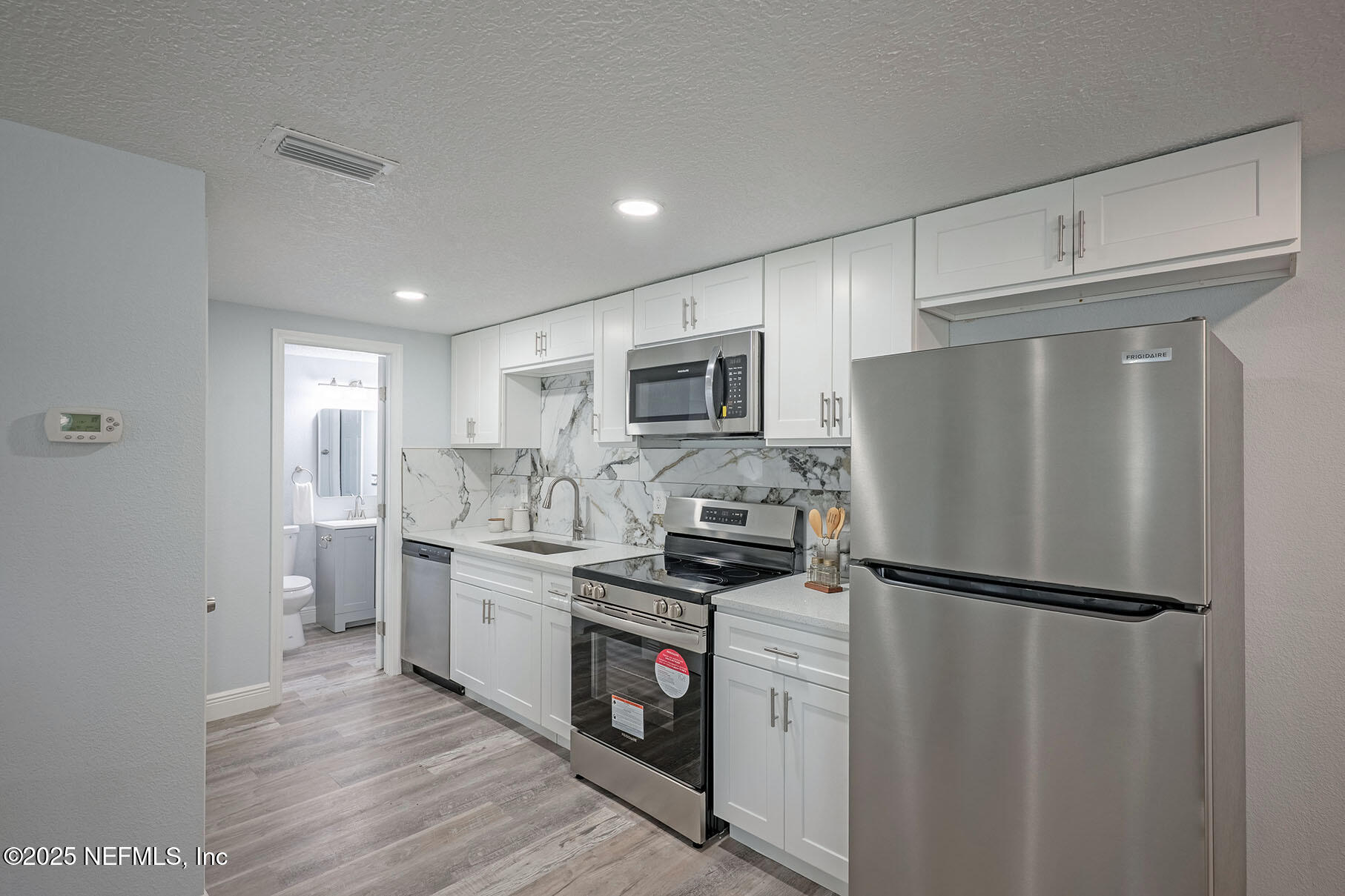 5401 Burdette Road Jacksonville, FL 32211 - Photo 39 of 53 a kitchen with stainless steel appliances a refrigerator stove and microwave