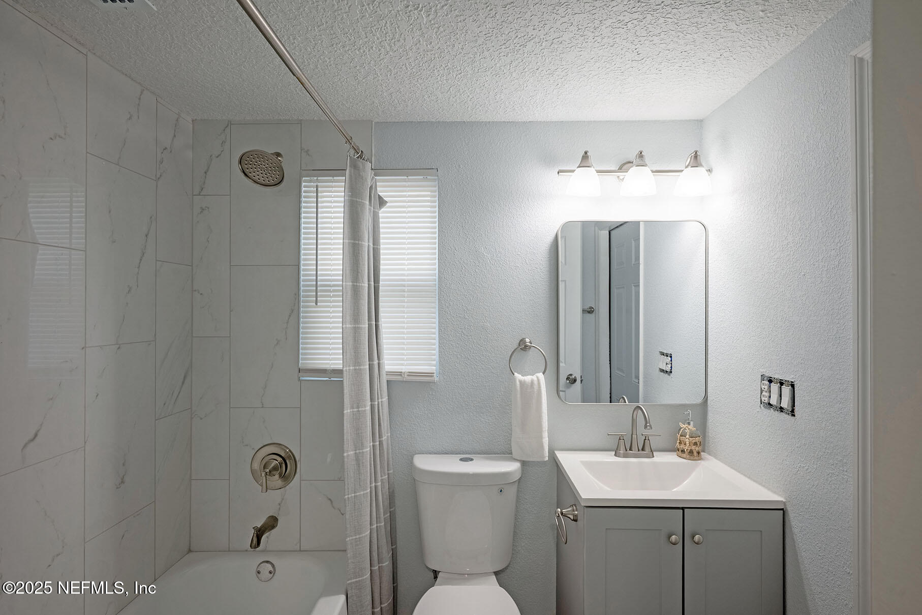 5401 Burdette Road Jacksonville, FL 32211 - Photo 42 of 53 a bathroom with a toilet a sink and mirror
