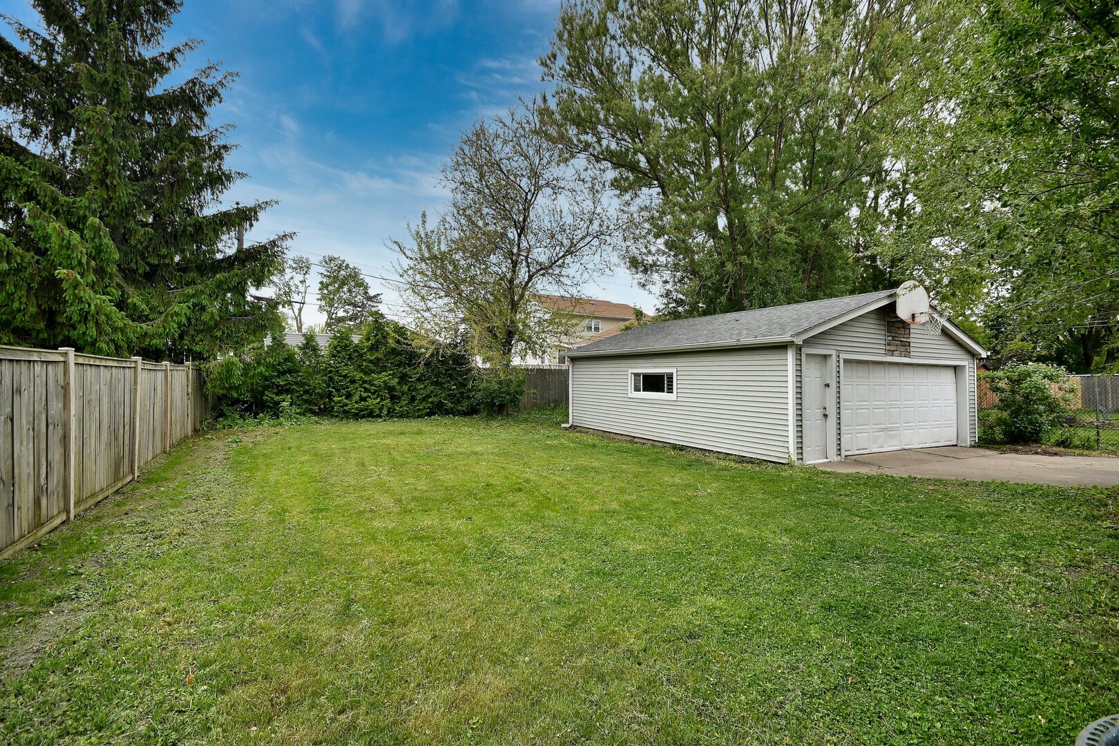 20564 Elizabeth Avenue Prairie View, IL 60089 - Photo 16 of 40 a view of a backyard with large trees and wooden fence