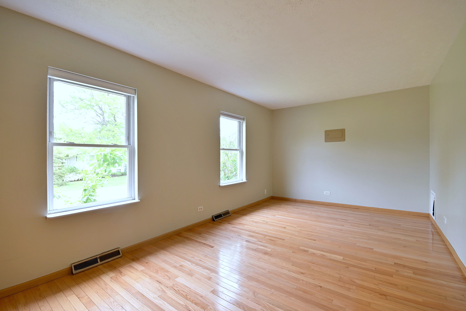 20564 Elizabeth Avenue Prairie View, IL 60089 - Photo 22 of 40 a view of an empty room with wooden floor and a window