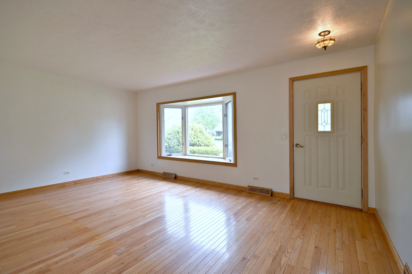 20564 Elizabeth Avenue Prairie View, IL 60089 - Photo 7 of 40 an empty room with wooden floor and windows