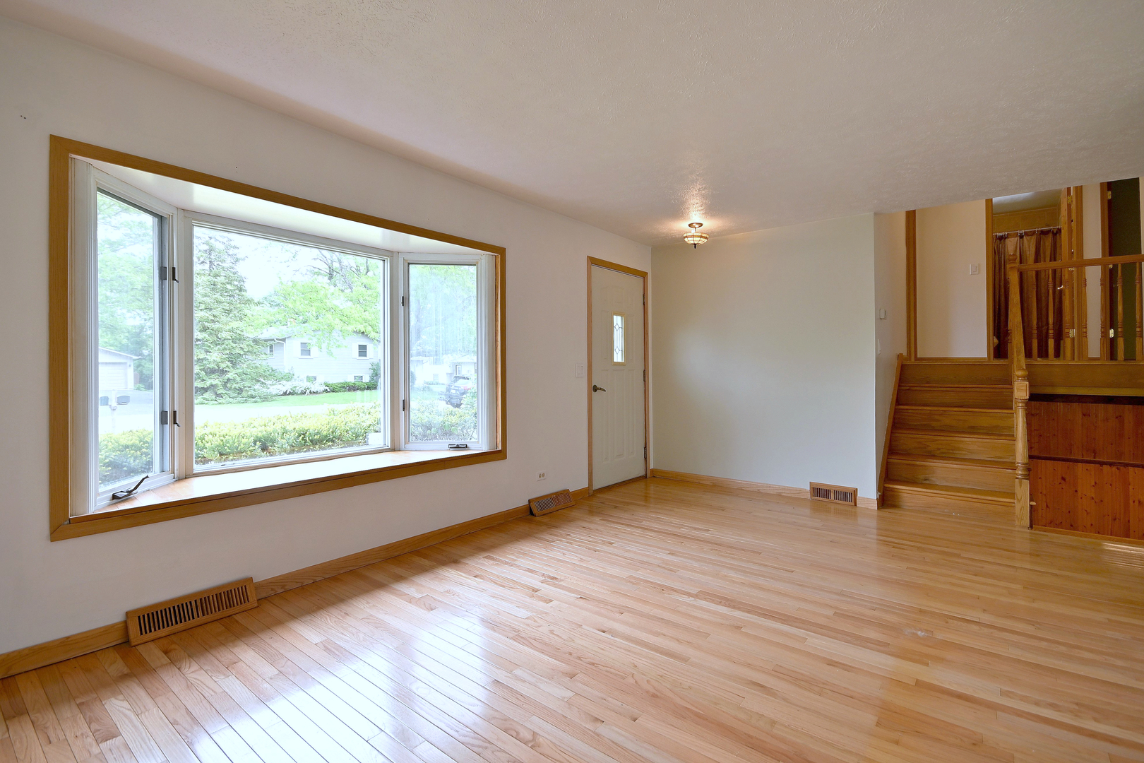 20564 Elizabeth Avenue Prairie View, IL 60089 - Photo 8 of 40 a view of an empty room with wooden floor and a window