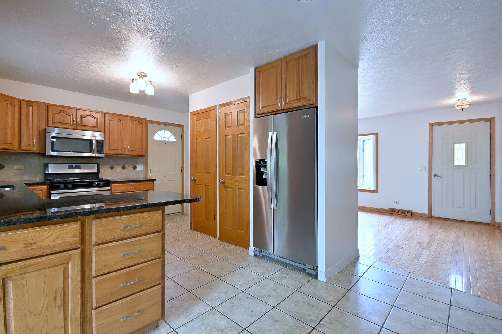 20564 Elizabeth Avenue Prairie View, IL 60089 - Photo 10 of 40 a kitchen with stainless steel appliances granite countertop a refrigerator and a stove top oven