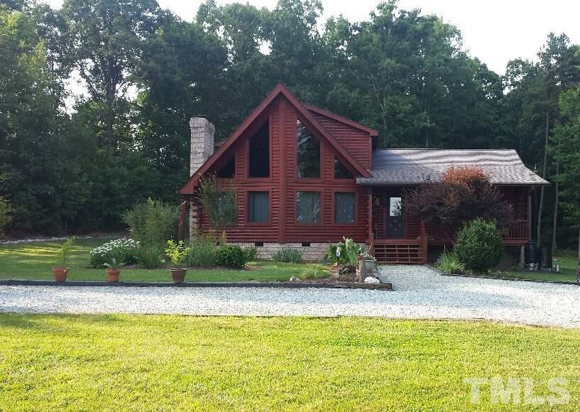4009 Pixley Pritchard Road Timberlake, NC 27583 - Photo 1 of 25 Beautiful log cabin with mature landscaping on 15 acres