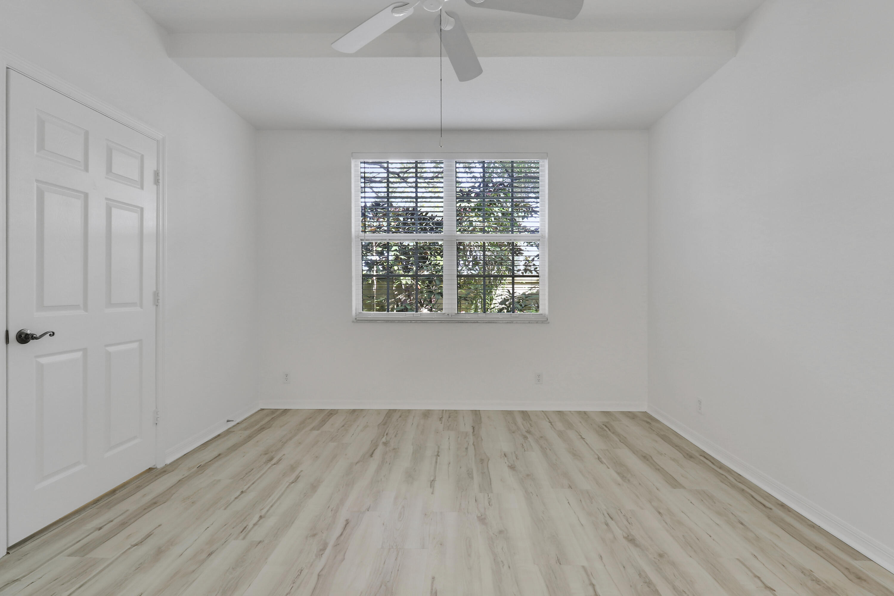 110 Lighthouse Circle, Unit A Tequesta, FL 33469 - Photo 19 of 41 wooden floor in an empty room with a window