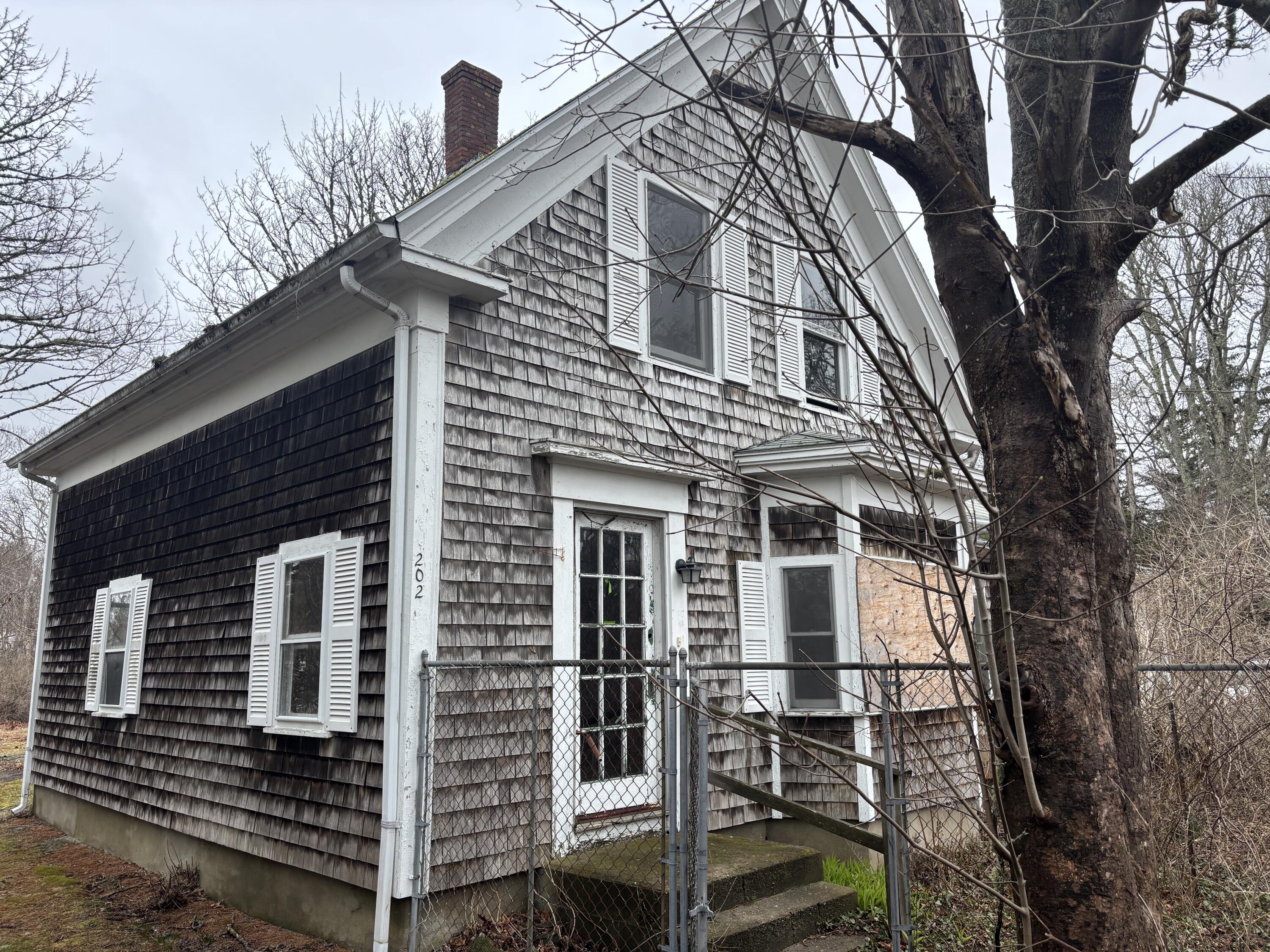 202 Route 28 West Harwich, MA 02671 - Photo 1 of 19 a front view of a house with wooden fence
