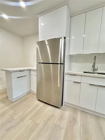 a white refrigerator freezer sitting in a kitchen