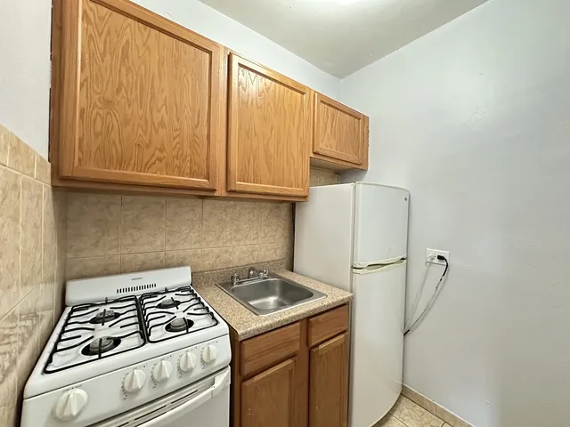 a kitchen with a stove and a cabinet