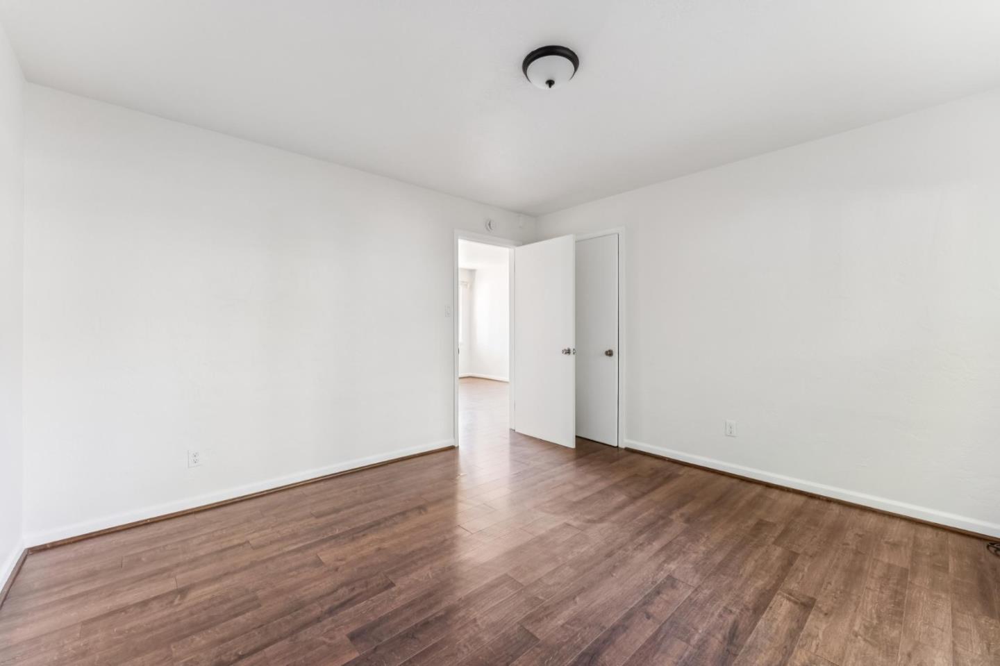 5664 Gaskill Street Oakland, CA 94608 - Photo 15 of 16 a view of an empty room with wooden floor