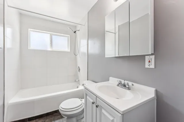 a bathroom with a sink toilet tub and shower