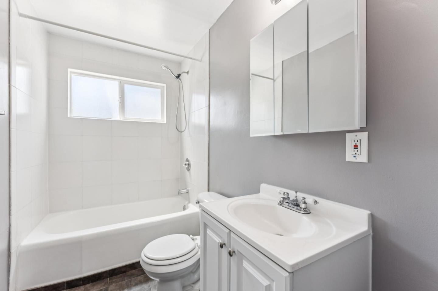 5664 Gaskill Street Oakland, CA 94608 - Photo 6 of 16 a bathroom with a sink toilet tub and shower