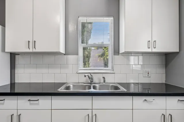 a kitchen with a sink and cabinets