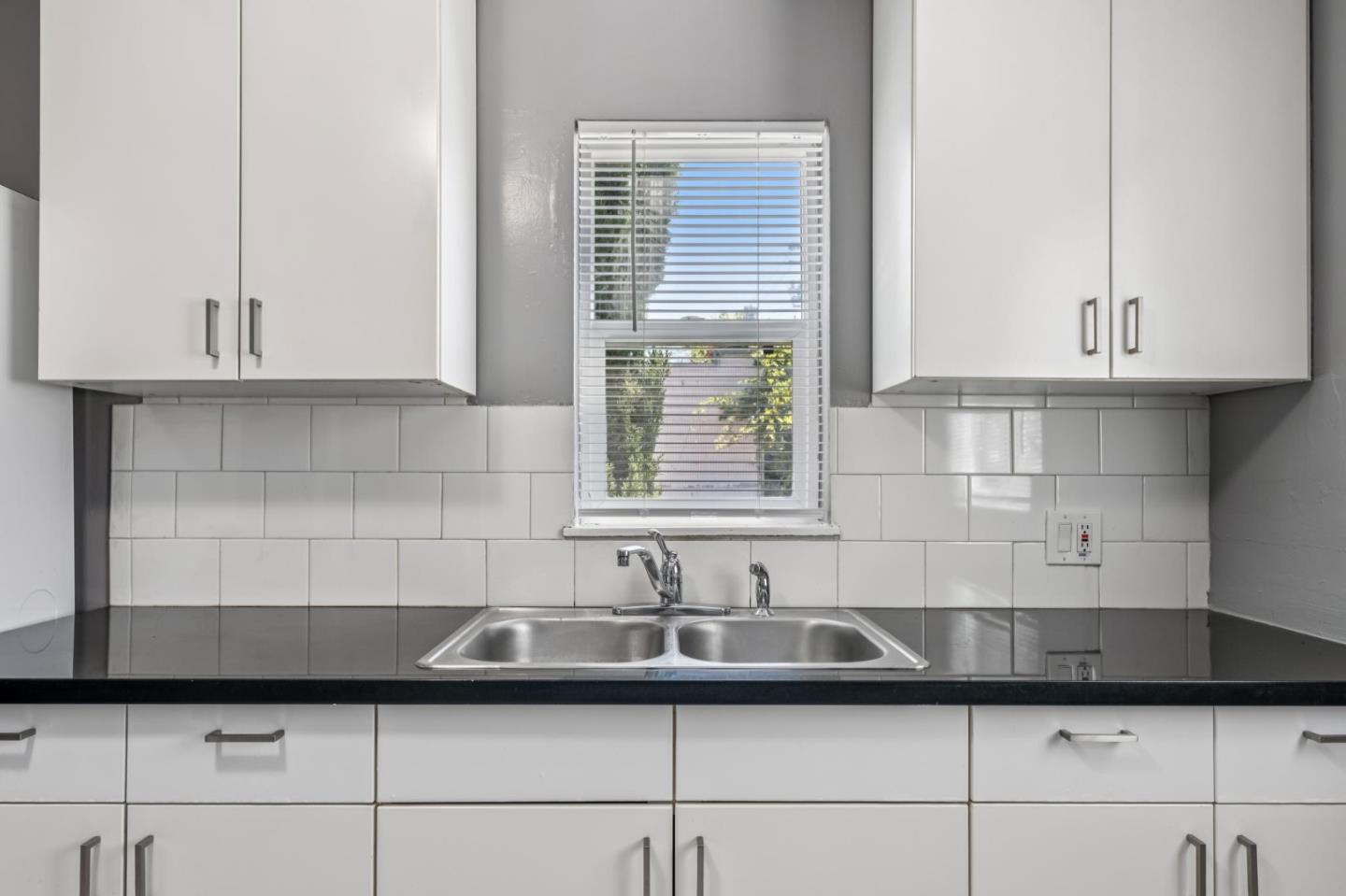 5664 Gaskill Street Oakland, CA 94608 - Photo 7 of 16 a kitchen with a sink and cabinets
