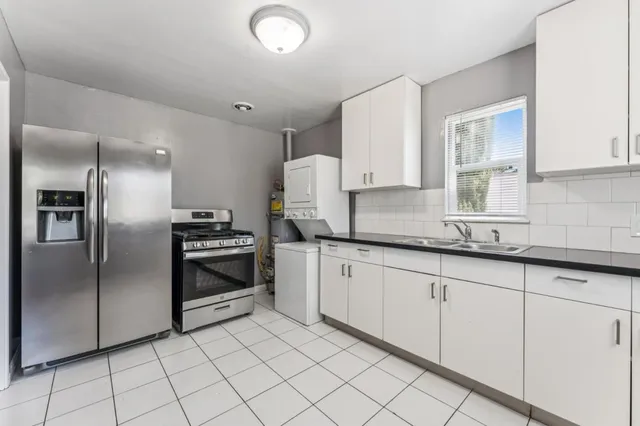 a kitchen with granite countertop a cabinets and steel stainless steel appliances