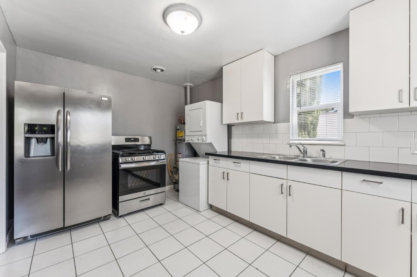 5664 Gaskill Street Oakland, CA 94608 - Photo 8 of 16 a kitchen with granite countertop a cabinets and steel stainless steel appliances