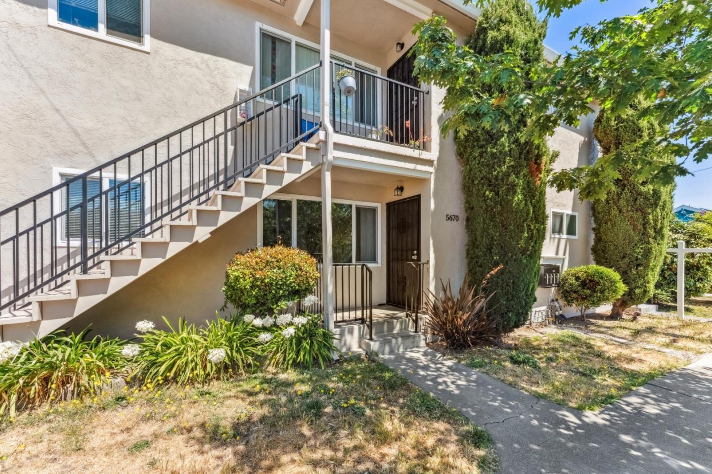5664 Gaskill Street Oakland, CA 94608 - Photo 10 of 16 a front view of a house with garden
