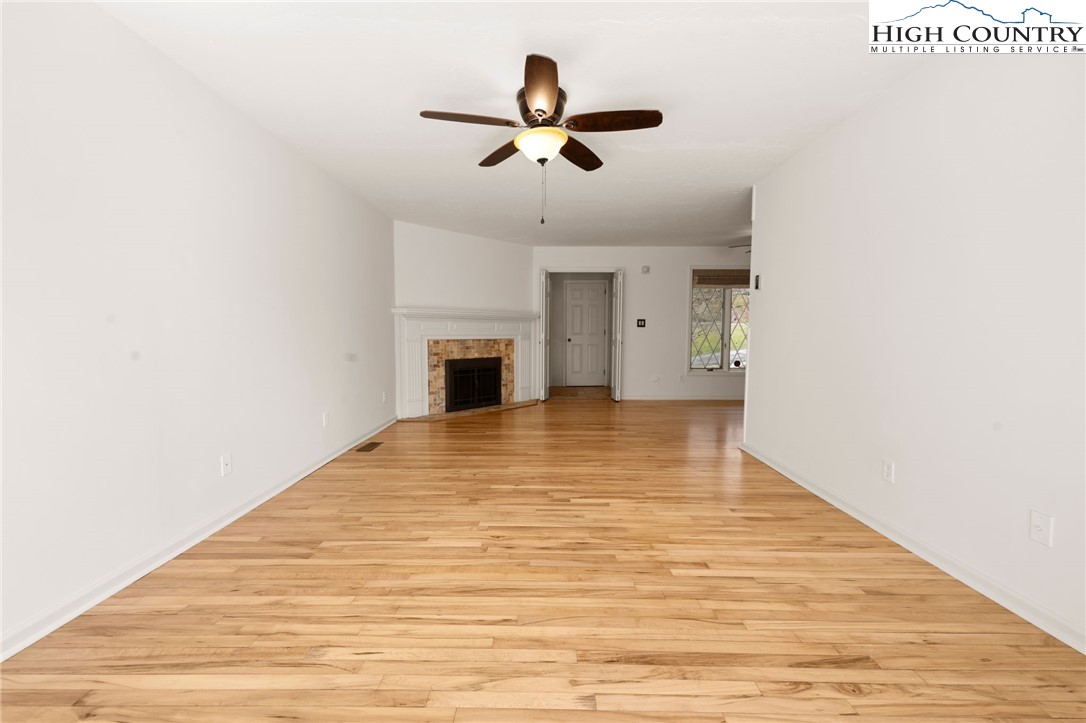 304 Glendale Drive Boone, NC 28607 - Photo 19 of 50 a view of empty room with wooden floor and ceiling fan