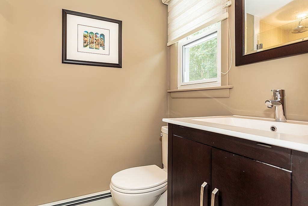 17 Dennett Road Winchester, MA 01890 - Photo 17 of 41 a bathroom with a toilet a sink and a window