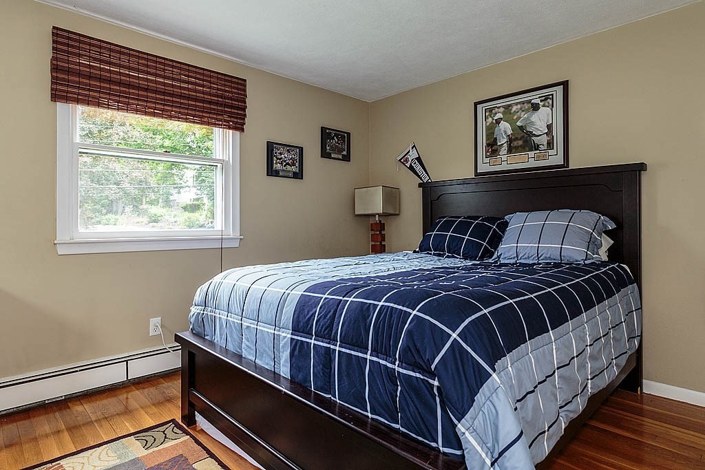 17 Dennett Road Winchester, MA 01890 - Photo 18 of 41 a bed sitting in a bedroom next to a window