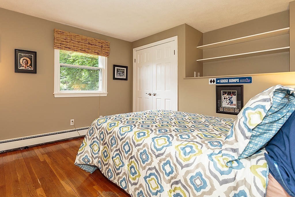 17 Dennett Road Winchester, MA 01890 - Photo 22 of 41 a bedroom with a bed and a window with chair