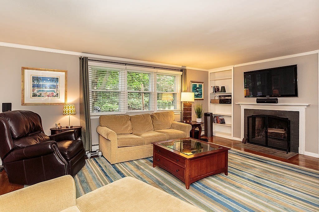17 Dennett Road Winchester, MA 01890 - Photo 7 of 41 a living room with furniture a flat screen tv and a fireplace