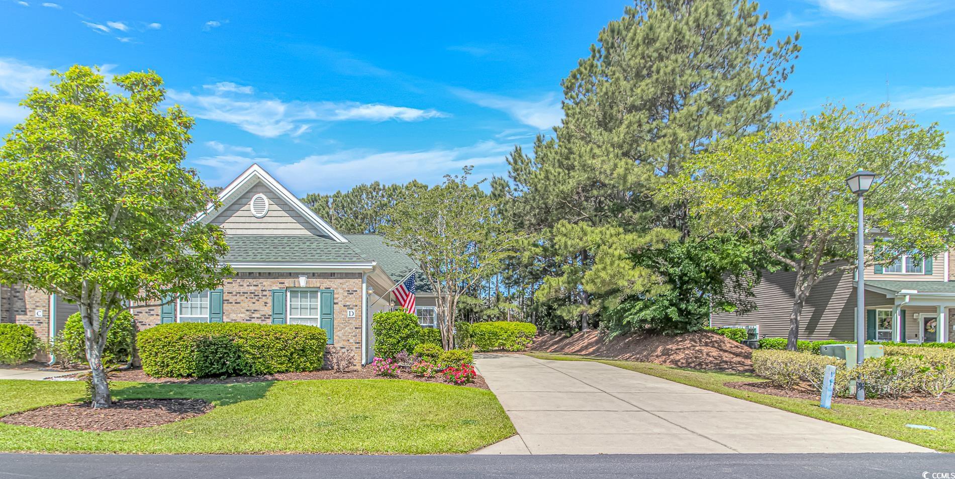 139 Chenoa Drive, Unit D Murrells Inlet, SC 29576 - Photo 1 of 34 View of front of property with brick siding, driveway, and a front yard
