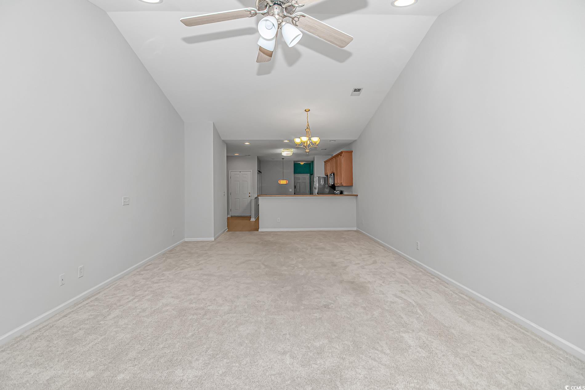 139 Chenoa Drive, Unit D Murrells Inlet, SC 29576 - Photo 11 of 34 Unfurnished living room with recessed lighting, a chandelier, light colored carpet, and ceiling fan