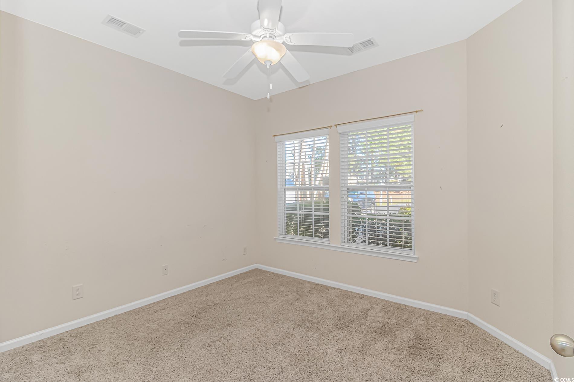 139 Chenoa Drive, Unit D Murrells Inlet, SC 29576 - Photo 18 of 34 Carpeted spare room featuring baseboards and ceiling fan