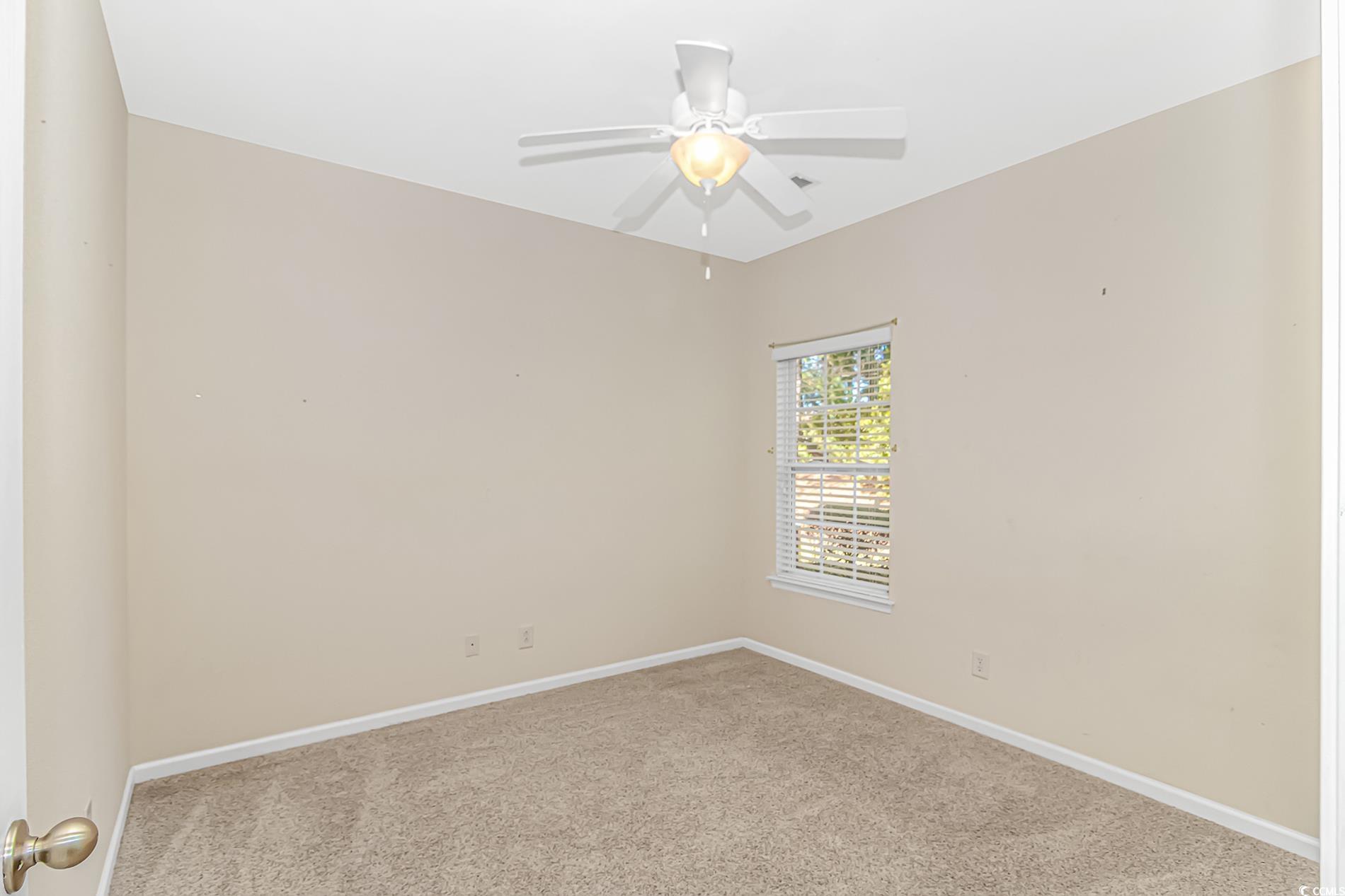 139 Chenoa Drive, Unit D Murrells Inlet, SC 29576 - Photo 20 of 34 Carpeted spare room with baseboards and a ceiling fan