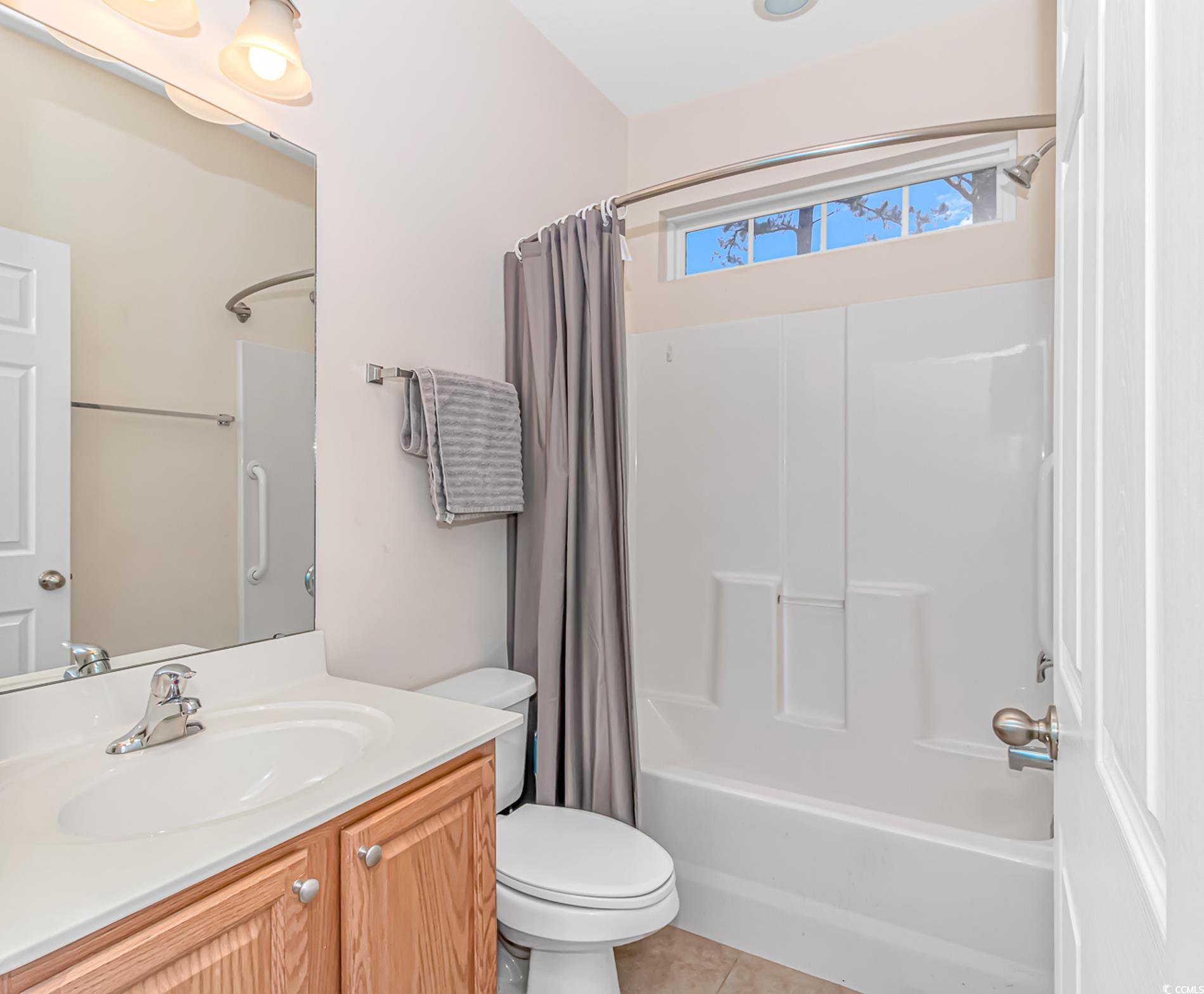139 Chenoa Drive, Unit D Murrells Inlet, SC 29576 - Photo 21 of 34 Full bathroom with toilet, tile patterned floors, shower / bath combination with curtain, and vanity